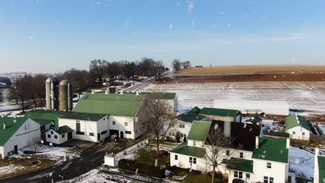 AERIAL-Flyover-Rural-Farm-Property-During-Snowfall