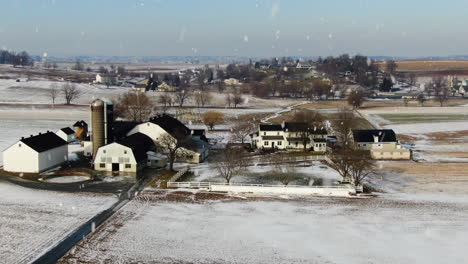 AERIAL-Flyover-Country-Farmhouse-And-Snow-Covered-Farmland