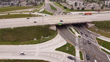 Driving-Through-Diverging-Diamond-in-Michigan,-USA-In-The-Afternoon---aerial-shot