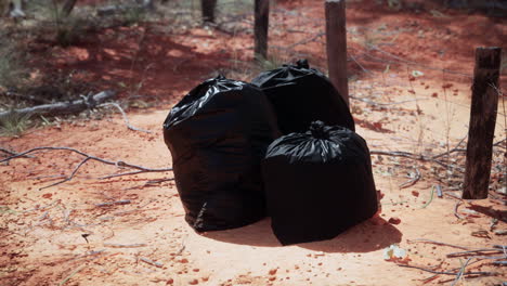 closeup-of-full-trash-bags-on-the-sand