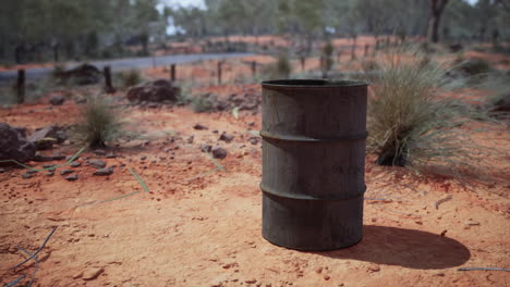 old-empty-rusted-barrel-on-sand