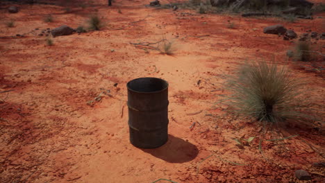 old-empty-rusted-barrel-on-sand