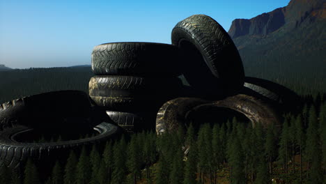 concept-of-environmental-pollution-with-big-old-tires-in-mountain-forest