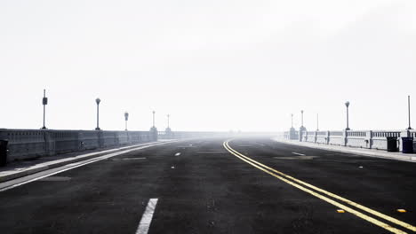 illuminated-empty-road-bridge-in-a-fog