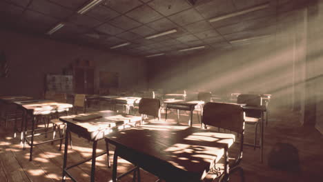 View-to-classroom-with-tables-and-small-blackboard-and-grungy-walls