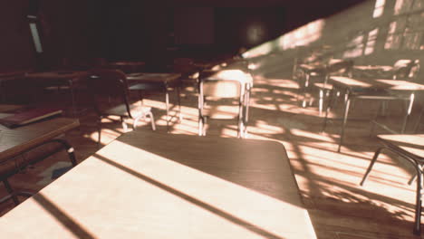 View-to-classroom-with-tables-and-small-blackboard-and-grungy-walls