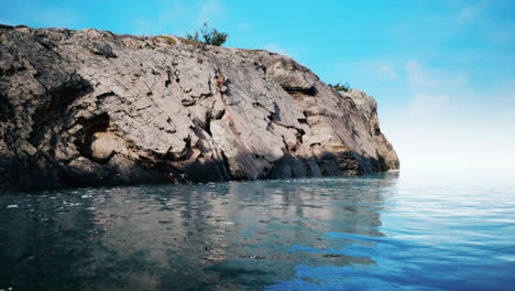 Tropische-Felseninsel-Gegen-Blauen-Himmel-Und-Meer