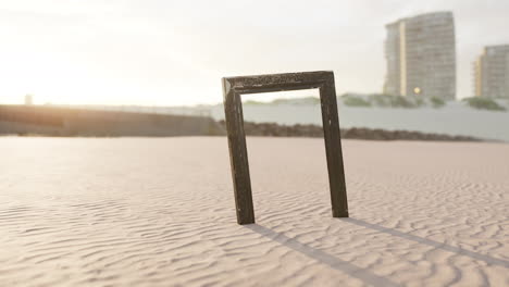 Empty-wooden-picture-frame-on-the-beach-sand