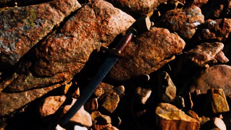 old-dagger-on-the-rock-at-sunset