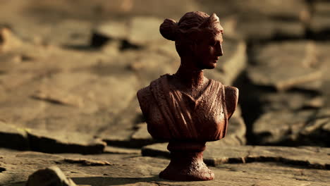 ancient-statue-of-woman-on-rocky-stones