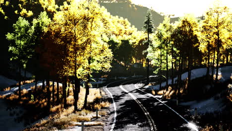 road-and-yellow-mountain-forest-at-sunset