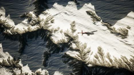 helicopter-above-mountains-in-snow
