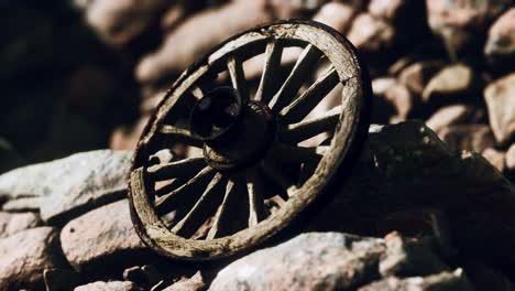 old-wooden-wheel-on-rocks
