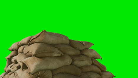 sandbags-for-flood-defense-or-military-use-on-green-chromakey-background