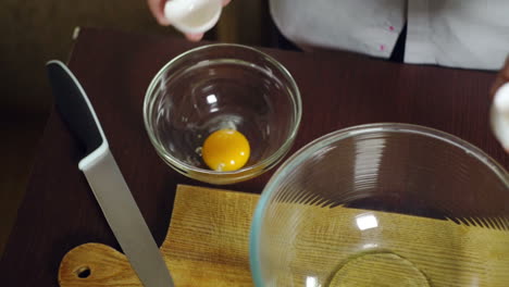 Egg-falling-in-glass-bowl.-Preparing-ingredients-for-baking-cake.-Cooking-food