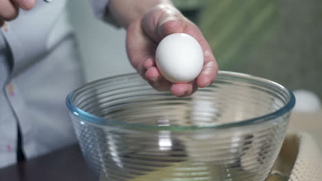 Preparing-food.-Break-egg.-Baking-ingredients.-Eggs-falling-into-glass-bowl