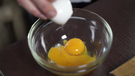 Baking-ingredient.-Fresh-egg-falling-into-bowl.-Cooking-food.-Food-ingredient