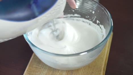 Whipping-cream-in-mixing-bowl.-Making-cream.-Baking-ingredients