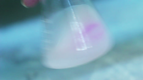 Chemical-reaction-in-flask.-Shaking-liquid-in-flask.-Laboratory-research