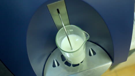 Glass-with-milk-in-laboratory-equipment-for-testing-dairy-products