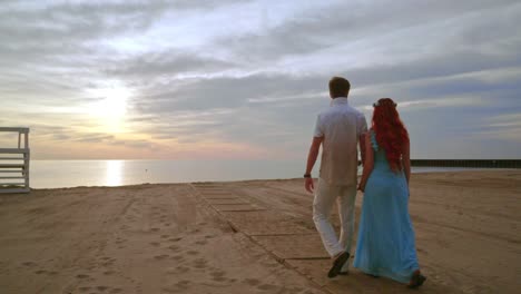 Love-couple-walking-on-sea-beach-at-sunrise.-Couple-beach