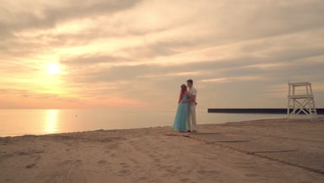 Couple-kissing-on-sea-beach-at-sunset.-Love-couple-hugging-on-beach