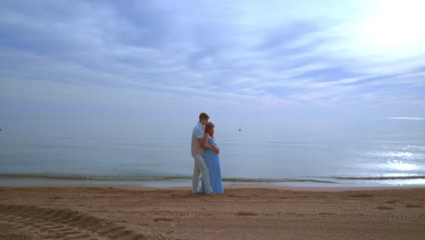 Love-couple-beach.-Pregnant-couple-hugging-on-sea-beach