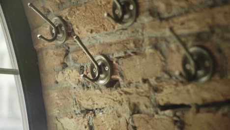Vintage-clothes-hook-on-brick-wall.-Wall-clothes-hanger-vintage-style