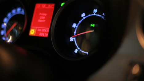 Dashboard-of-moving-car.-Tachometer-arrow-revving-in-moving-car
