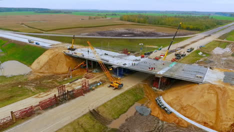 Road-construction.-View-from-above-bridge-construction-over-car-highway