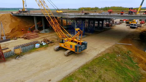 Bridge-construction.-Sky-view-of-crawler-crane-repair-bridge-over-highway-road