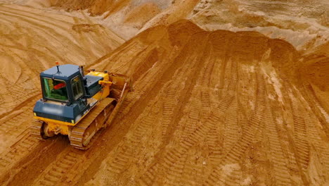 Crawler-bulldozer-standing-at-sand-mine.-Construction-machinery-at-sand-quarry