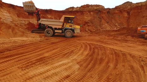 Dumper-truck-at-sand-mine.-Drone-view-of-mining-truck-working-at-sand-quarry