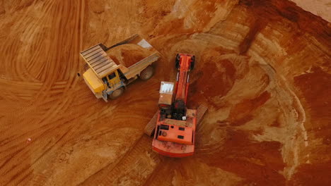 Excavator-loading-mining-truck-at-sand-quarry.-Sand-mining-industry