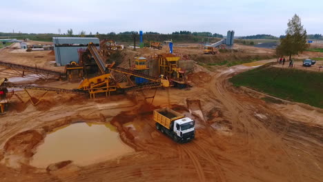 Sand-extraction-at-quarry.-Mining-conveyor-pour-sand-in-dumper-truck