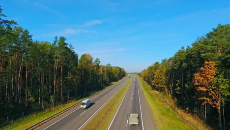 Aerial-view-cars-driving-on-highway-road-in-forest.-Highway-forest