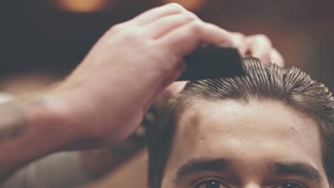 Man-combing-hair.-Barber-haircut.-Hairdressing.-Hairdresser-styling-hair