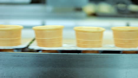 Food-production-line.-Waffle-cone-manufacturing-line.-Waffle-cup-on-conveyor