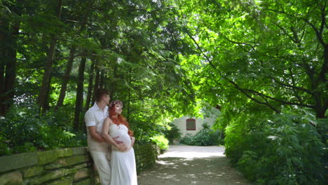 Pregnant-couple-hugging-at-summer-park.-Romantic-couple-relax-outdoor