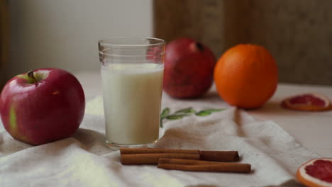 Fruits-and-milk-glass-on-kitchen-table.-Healthy-breakfast.-Fresh-apple