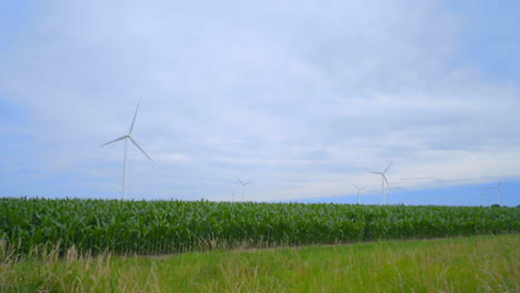Wind-turbines-on-green-field-under-clouds-sky.-Wind-turbines-field