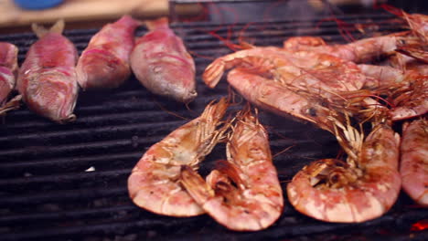 Panorama-of-grilled-red-shrimps-and-other-seafood-on-barbecue.