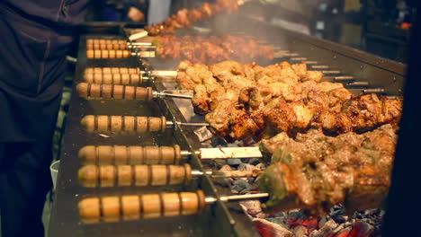 Grilled-meat-on-skewers.-Street-food.-Meat-rotating-on-skewer