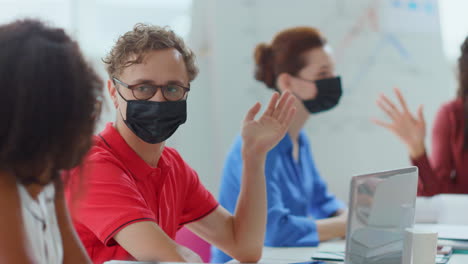 Masked-people-working-in-office.-Protected-man-talking-colleagues.