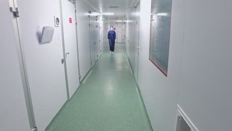 Walking-through-laboratory-corridor.-Female-worker-going-chemical-lab-corridor