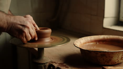 Man-sculpting-in-pottery-on-master-class.-Master-working-with-clay-in-workshop