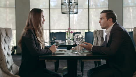 Business-man-and-woman-talking-in-restaurant.-Businessman-and-businesswoman