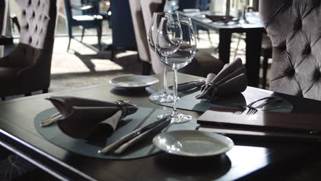 Wine-glass-and-plate-for-dinner-in-restaurant.-Tableware-set-on-dining-table