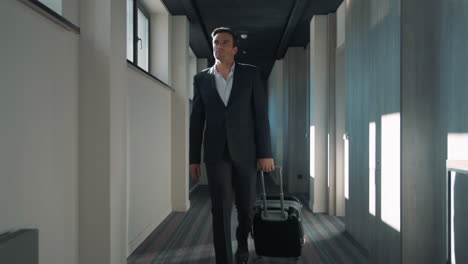 Business-man-walking-at-hotel-corridor.-Businessman-arriving-at-business-hotel
