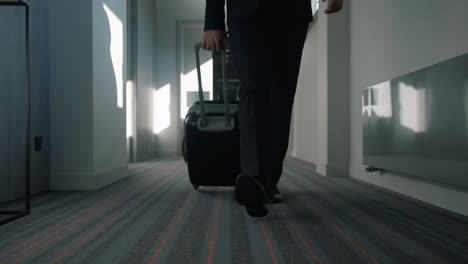 Business-man-legs-with-travel-suitcase-walking-at-hotel-corridor